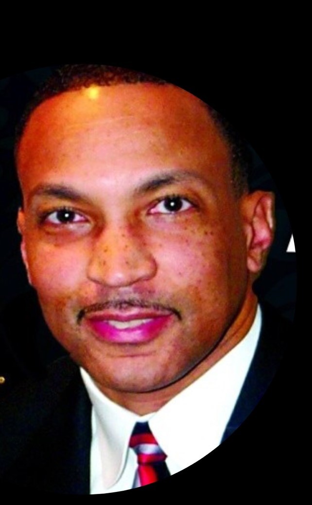 Headshot of Alfred Reeves, in black blazer and white dress shirt.